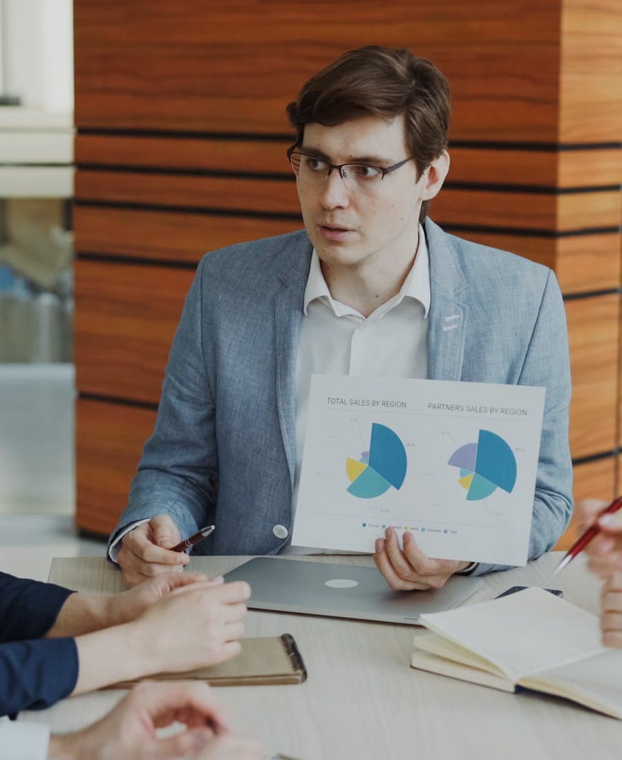 Team strategizing with charts and business plans in a meeting room